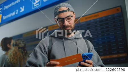 Airport Terminal: Happy Man Scanning Plane Ticket Using Smartphone 122609598
