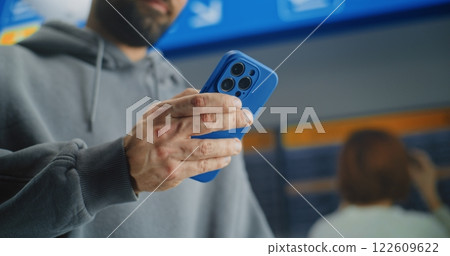 Close Up of Male Passenger Scanning Plane Ticket Using Phone to Check Flight Information Close Up of Male Passenger Scanning Plane Ticket Using Phone to Check Flight Information 122609622