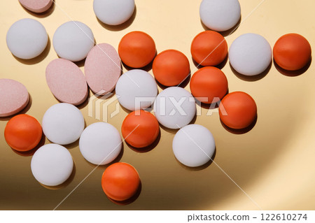 Colorful pills on a golden background. Colorful pills on a golden background. 122610274