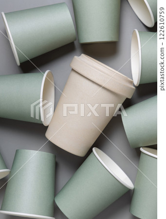 New light green paper cups and reusable bamboo coffee cup on a gray top view, mockup 122610759