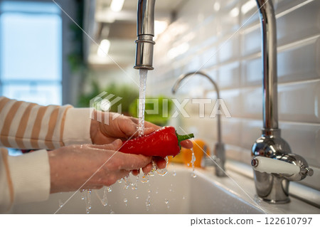 Cleaning of fresh fruit and vegetables, red ramiro pepper for salad. Natural nutrition ingredients 122610797