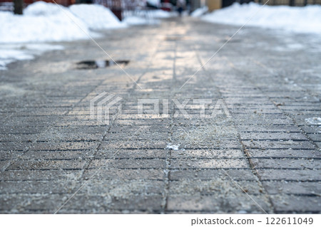 Road surface treated with technical salt to prevent ice formation, salt puddles on the road Road surface treated with technical salt to prevent ice formation, salt puddles on the road 122611049