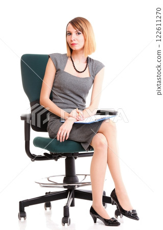 Full length business woman sitting on chair holding clipboard isolated Full length business woman sitting on chair holding clipboard isolated 122611270