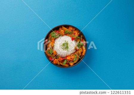top shot on blue background black salad plate with Chinese rice and cabbage kim chi asian cuisine healthy eating 122611331