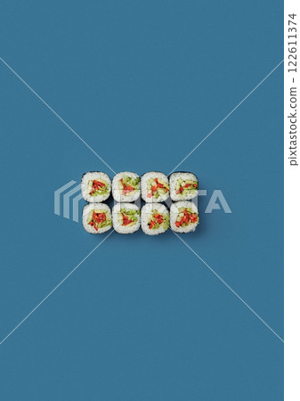 on blue background lies a set of sushi with rice and fresh vegetables wrapped in a sheet of nori vegan food professional Japanese cuisine kitchen sushi without shade on blue background lies a set of sushi with rice and fresh vegetables wrapped in a sheet of nori vegan food professional Japanese cuisine kitchen sushi without shade 122611374