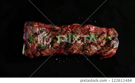 Arrachera steak grilled and garnished, top view. Black background with copy space 122611484