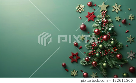 A green background with a Christmas tree filled with decorations, snowflakes and stars with copy space 122611560