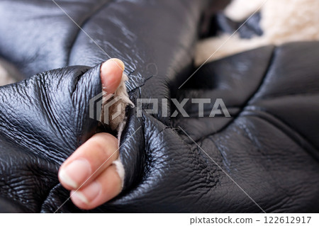 A CloseUp Image of a Hand Gripping HighQuality Leather Gloves in Detail and Texture 122612917