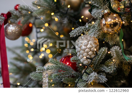 Close up of a decorated Christmas tree with lights and ornaments 122612960