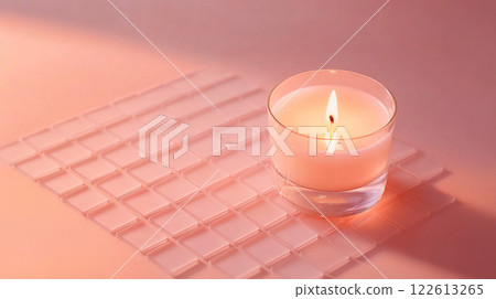 An elegant candle and beautiful glass tiles create a captivating scene against a pink background 122613265