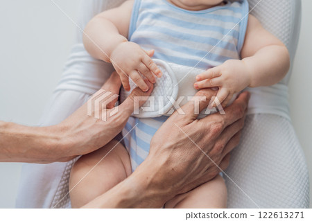 Adorable 3-month-old baby lying safely in a cozy infant cocoon secured with a special safety belt. Comfortable and protective design for newborn care. Parenting, safety, and baby comfort concept Adorable 3-month-old baby lying safely in a cozy infant cocoon secured with a special safety belt. Comfortable and protective design for newborn care. Parenting, safety, and baby comfort concept 122613271