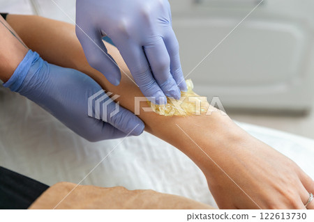 Procedure of hair removing on arm beautiful woman with sugar paste or wax honey Procedure of hair removing on arm beautiful woman with sugar paste or wax honey 122613730