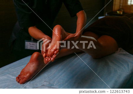 Close-up of feet, woman having leg rehabilitation massage. Close-up of feet, woman having leg rehabilitation massage. 122613743