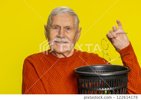 Man taking off, throwing out glasses into bin after medical vision laser treatment therapy surgery 122614178