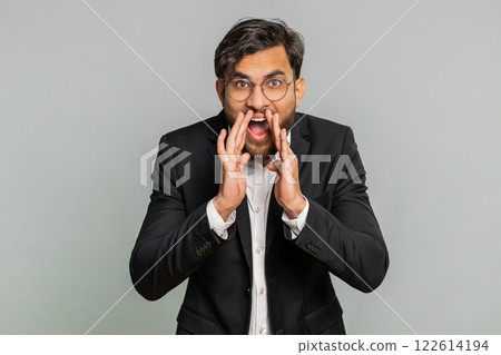 Indian businessman whisper news rumors holding hands near mouth, share gossip quiet, keep my secrets Indian businessman whisper news rumors holding hands near mouth, share gossip quiet, keep my secrets 122614194