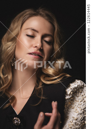 A beautiful beautiful woman with blonde hair looks 122614445