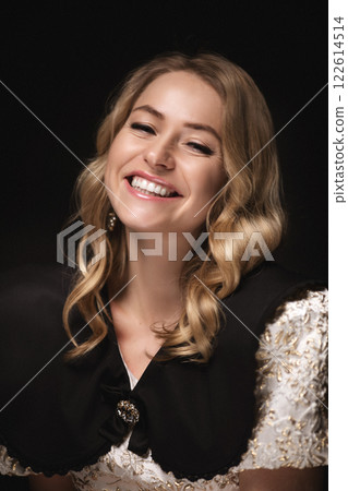 Beautiful blonde in a dress, portrait on a black 122614514