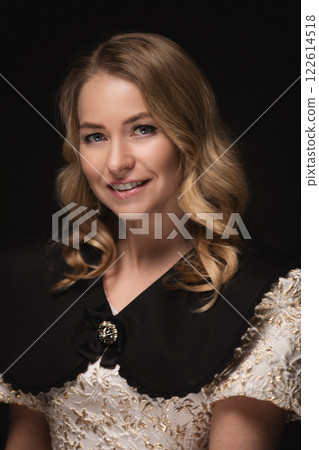 Beautiful blonde in a dress, portrait on a black 122614518