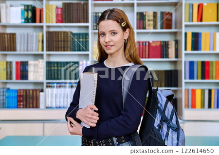 Portrait of smiling teenage girl student, inside high school building 122614650