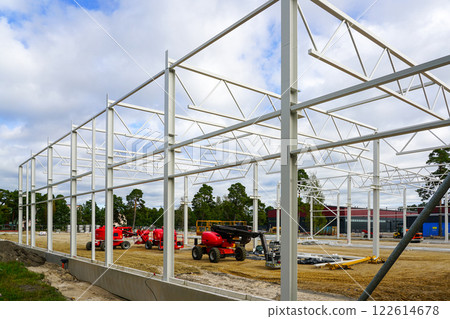 Modern self propelled construction hydraulic lifts on modern metal frame building construction site 122614678