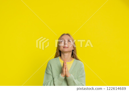 Middle-aged woman praying making wish, asking hopeful help, begging apology, meditation, imploring Middle-aged woman praying making wish, asking hopeful help, begging apology, meditation, imploring 122614689