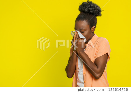 African American woman wipes nose snot with napkin, tired expression, cold symptoms, viral allergy 122614726