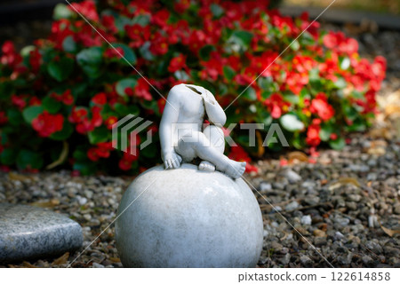 damaged headless cherub on a grave 122614858