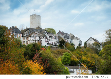 view of the romantic eifel village of Reifferscheid with its half-timbered houses and medieval castle in the colorful autumn view of the romantic eifel village of Reifferscheid with its half-timbered houses and medieval castle in the colorful autumn 122615427