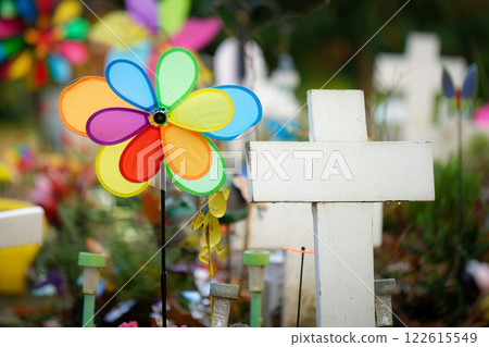 white crosses and colorful toys in a sad children's cemetery 122615549