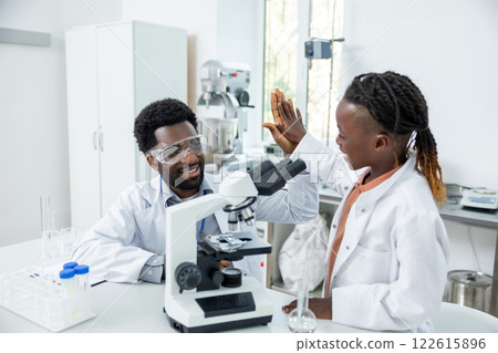 Teacher and student in lad coats looking happy and contented 122615896