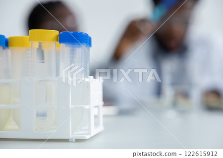 Teacher and student working in a school laboratory and looking involved and focused Teacher and student working in a school laboratory and looking involved and focused 122615912
