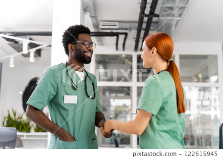 Professional doctors shaking hands at medical office meeting 122615945