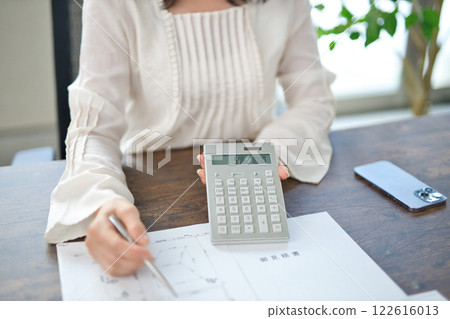 The hands of a middle-aged woman explaining a real estate contract The hands of a middle-aged woman explaining a real estate contract 122616013