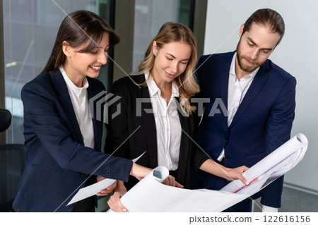 Young specialists in the office looking busy and involved 122616156
