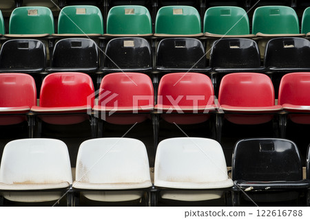 Colorful Plastic Seats Arrangement at the Arena Stadium with Diverse Rows for Spectators Colorful Plastic Seats Arrangement at the Arena Stadium with Diverse Rows for Spectators 122616788
