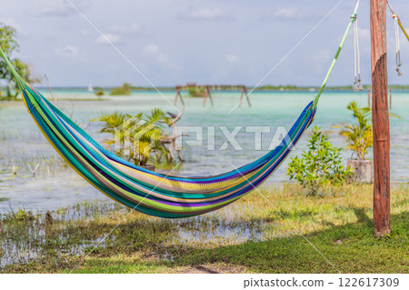 Turquoise waters of Bacalar Lake, Mexico. Peaceful and scenic tropical destination. Travel, relaxation, and nature concept Turquoise waters of Bacalar Lake, Mexico. Peaceful and scenic tropical destination. Travel, relaxation, and nature concept 122617309