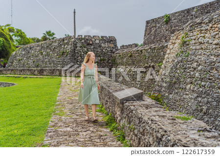 Female tourist exploring Fuerte de San Felipe de Bacalar, Mexico. Quintana Roo travel, historical adventure, and cultural heritage concept 122617359