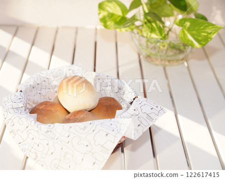 Fresh bread buns in basket on table. Breakfast buns. Fresh bread buns in basket on table. Breakfast buns. 122617415