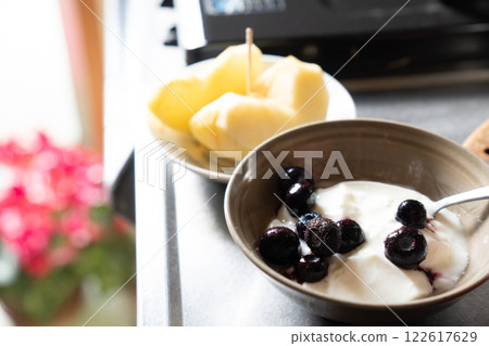 Start your day with blueberry yogurt and an apple 122617629