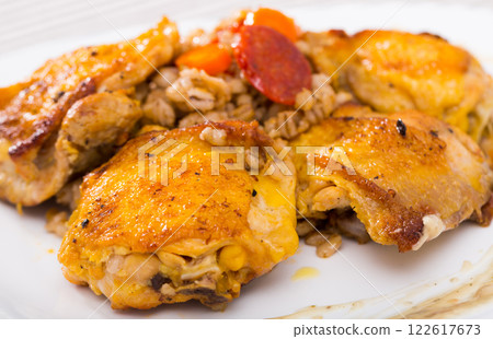 Closeup of tasty chicken thighs with pearl barley at plate Closeup of tasty chicken thighs with pearl barley at plate 122617673