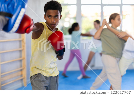 Coach and boy training boxing technique 122617707