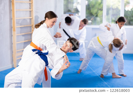 Boy and girl training judo technique 122618003