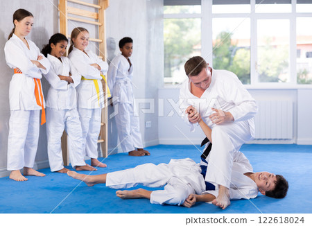 Coach and boy training judo technique 122618024