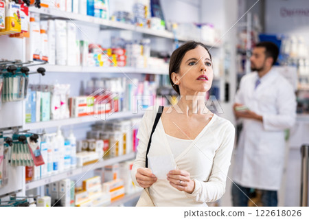 Woman with recipe shopping in pharmacy 122618026