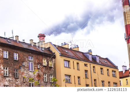 Smoke rises from the pipes of an old house in the city Smoke rises from the pipes of an old house in the city 122618113