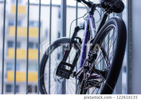 An adult bicycle stands on the balcony of an apartment in the city An adult bicycle stands on the balcony of an apartment in the city 122618135