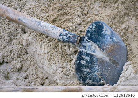 Shovel in a pile of sand at a construction site Shovel in a pile of sand at a construction site 122618610
