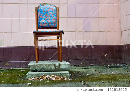 Rest coffee break.Wooden chair,blue upholstery,concrete slabs,pink tiled wall Rest coffee break.Wooden chair,blue upholstery,concrete slabs,pink tiled wall 122618625