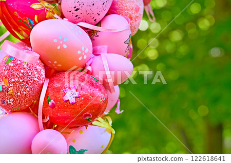 Spring bouquet of colorful painted Easter eggs on green tree 122618641