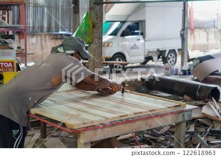 Carpenter build furniture at wood factory for sale 122618963